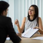 Female faculty member asking IIM interview questions to a male candidate